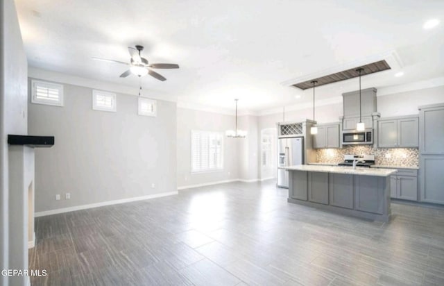 kitchen with stove, stainless steel microwave, ceiling fan with notable chandelier, gray cabinetry, and refrigerator with ice dispenser