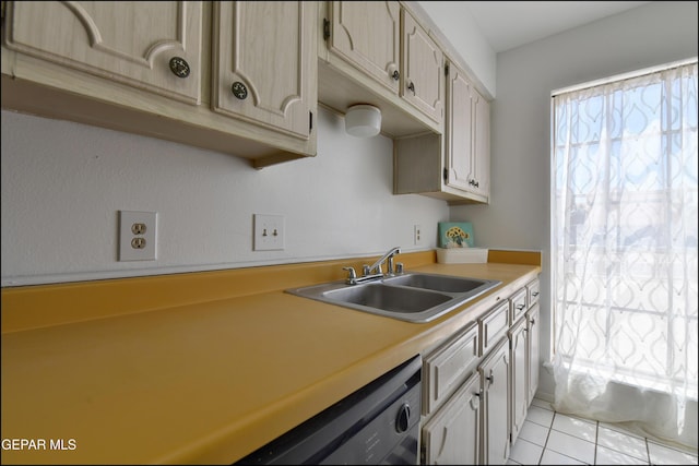 kitchen with light tile patterned floors, dishwasher, a sink, and light countertops