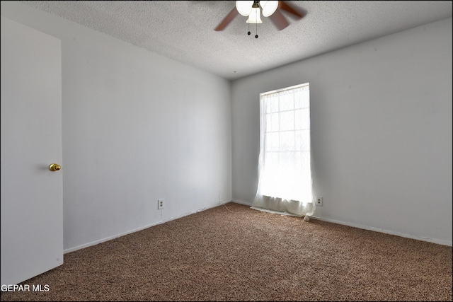 carpeted spare room featuring a ceiling fan and a textured ceiling