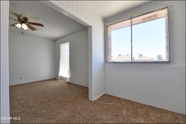 empty room with a ceiling fan and carpet
