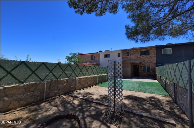 rear view of house featuring a fenced backyard and a patio area