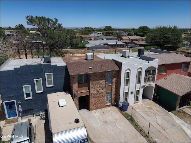 view of front of house featuring stucco siding, central AC unit, and a residential view