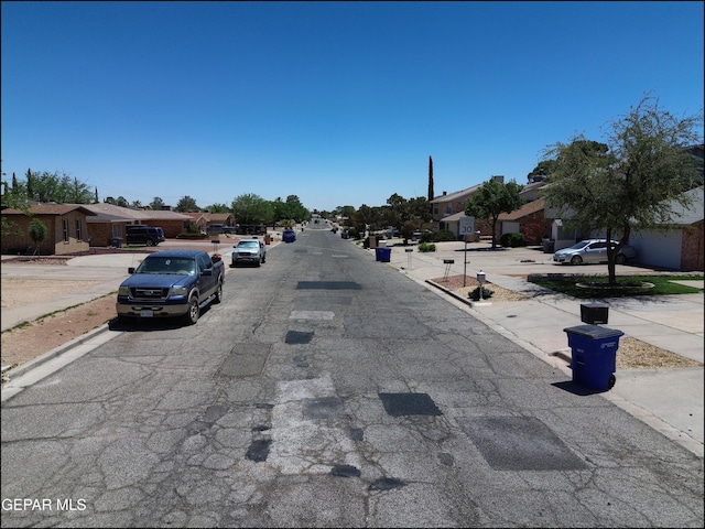 view of street featuring curbs, sidewalks, and a residential view