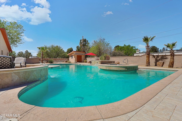 5673 Upper Valley Rd, El Paso, TX 79932 - view of pool with a fenced backyard, an outbuilding, a pool with connected hot tub, and a storage shed