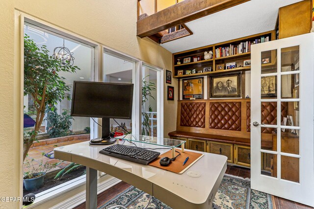 5673 Upper Valley Rd, El Paso, TX 79932 - office area with a textured wall and dark wood finished floors