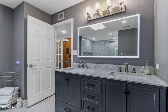 5673 Upper Valley Rd, El Paso, TX 79932 - bathroom with tile patterned floors, visible vents, a walk in shower, and a sink