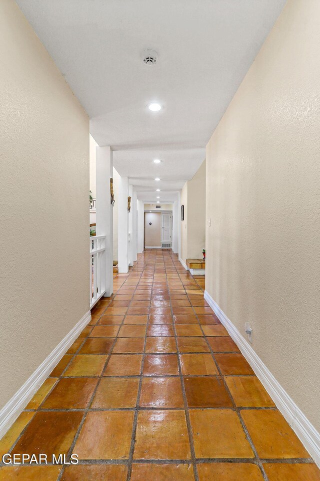 5673 Upper Valley Rd, El Paso, TX 79932 - corridor featuring baseboards, recessed lighting, tile patterned floors, and a textured wall
