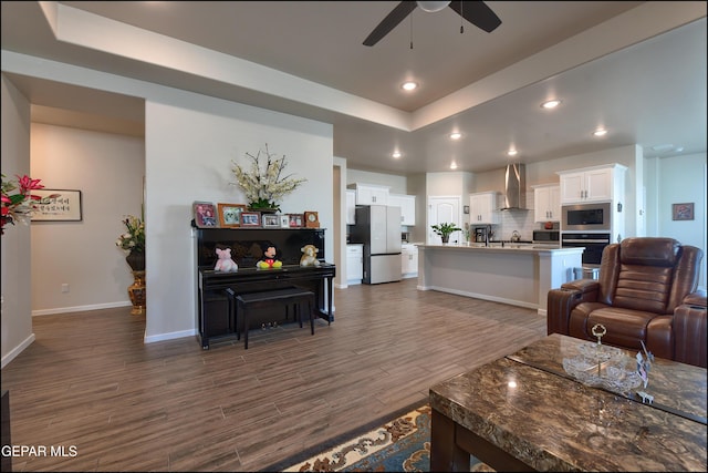 13162 Cleethorpes St, El Paso, TX 79928 - living area featuring ceiling fan, a tray ceiling, baseboards, recessed lighting, and dark wood finished floors