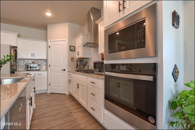 13162 Cleethorpes St, El Paso, TX 79928 - kitchen with a toaster, appliances with stainless steel finishes, backsplash, white cabinetry, and wall chimney exhaust hood