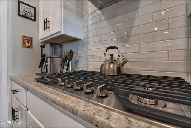 13162 Cleethorpes St, El Paso, TX 79928 - room details featuring light stone countertops, white cabinets, stainless steel gas stovetop, and tasteful backsplash