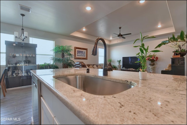 13162 Cleethorpes St, El Paso, TX 79928 - kitchen with open floor plan, a sink, a raised ceiling, and visible vents
