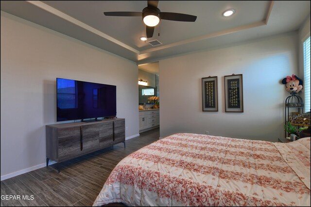 13162 Cleethorpes St, El Paso, TX 79928 - bedroom featuring dark wood finished floors, recessed lighting, baseboards, visible vents, and a tray ceiling