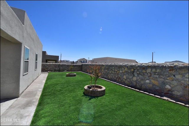13162 Cleethorpes St, El Paso, TX 79928 - view of yard featuring an outdoor fire pit and a fenced backyard