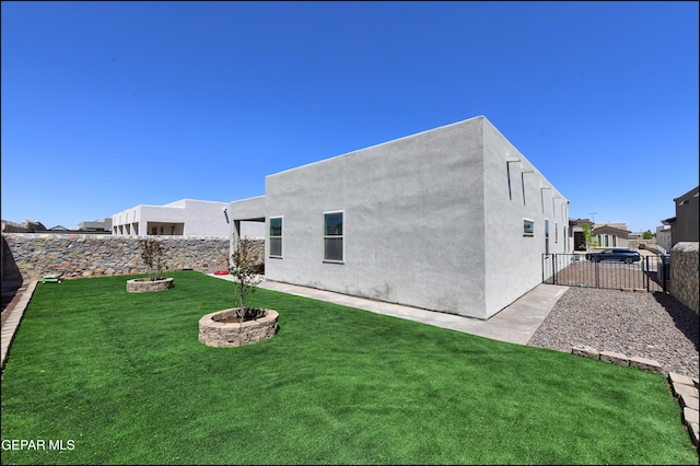 13162 Cleethorpes St, El Paso, TX 79928 - rear view of property with stucco siding, a fire pit, a yard, and a fenced backyard