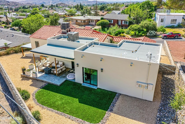 back of property with stucco siding, fence, a residential view, a patio area, and a mountain view