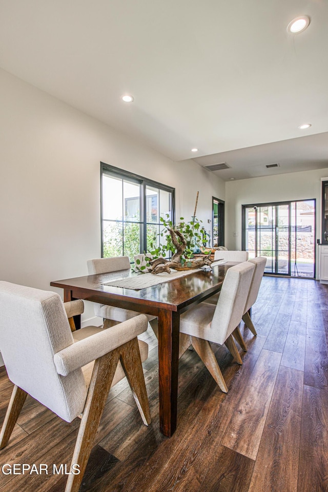 dining area featuring recessed lighting, visible vents, hardwood / wood-style flooring, and a healthy amount of sunlight
