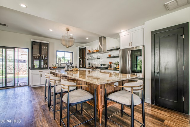 kitchen featuring light stone counters, visible vents, open shelves, and dark wood-style floors