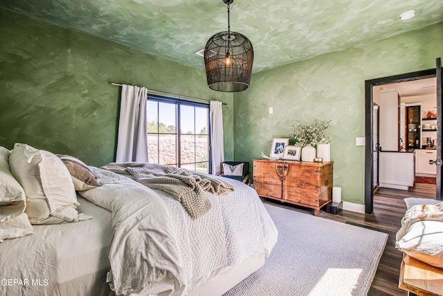 bedroom featuring wood finished floors and baseboards