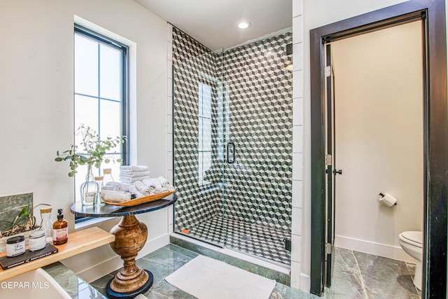 bathroom with recessed lighting, toilet, a stall shower, marble finish floor, and baseboards