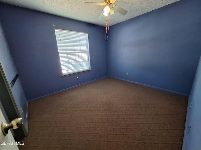carpeted spare room featuring baseboards, ceiling fan, and a textured ceiling