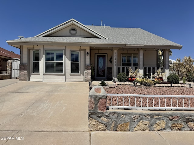 view of front facade featuring a porch, fence private yard, and roof with shingles