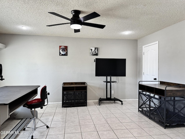 office space featuring light tile patterned floors, a ceiling fan, and a textured ceiling