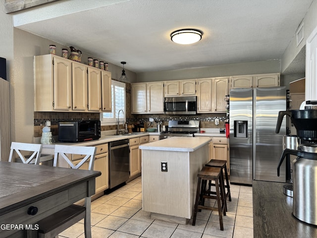 kitchen with a sink, decorative backsplash, appliances with stainless steel finishes, and a toaster