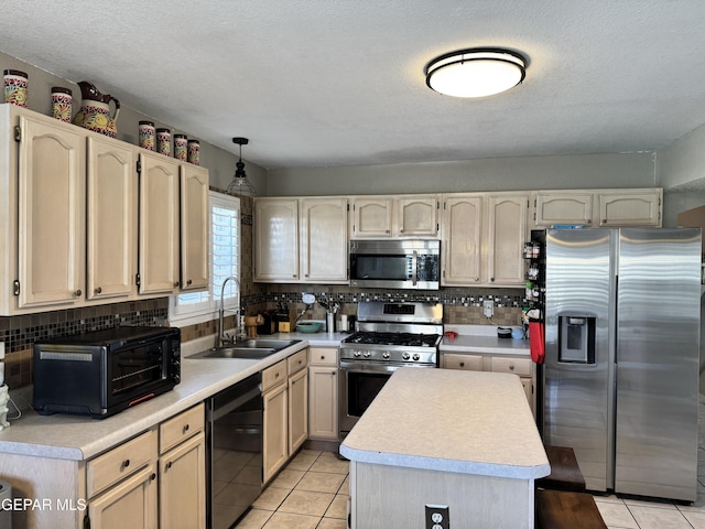 kitchen featuring a sink, light countertops, tasteful backsplash, and stainless steel appliances