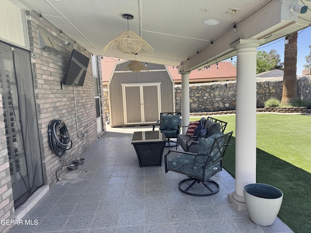 view of patio / terrace featuring a storage unit, an outdoor structure, and an outdoor living space
