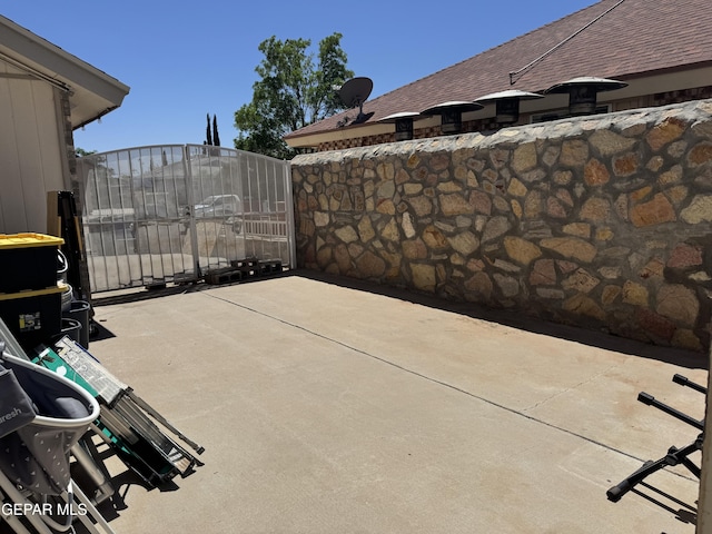 view of patio / terrace featuring fence and a gate