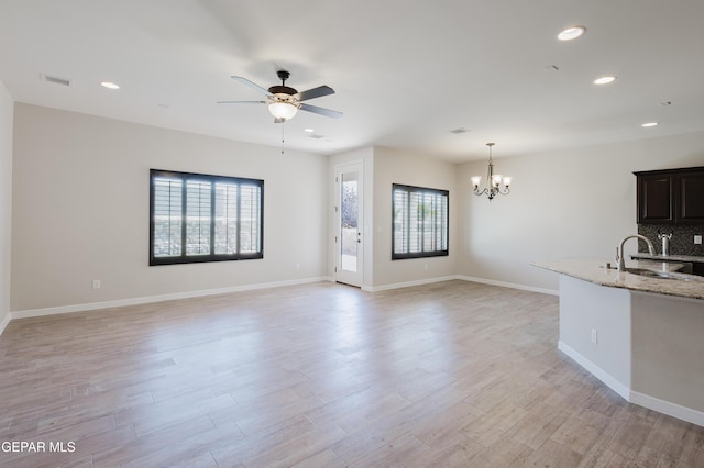 13145 Hazy, El Paso, TX 79938 - unfurnished living room featuring plenty of natural light, recessed lighting, a chandelier, a ceiling fan, and light wood-type flooring