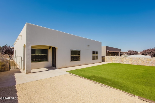 13145 Hazy, El Paso, TX 79938 - back of house with a lawn, stucco siding, a patio, and a gate