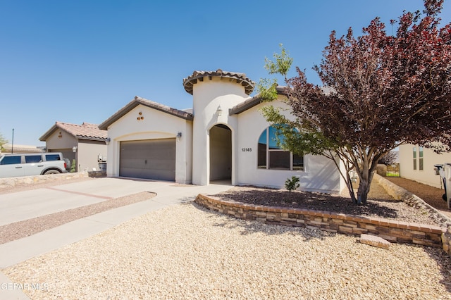13145 Hazy, El Paso, TX 79938 - mediterranean / spanish-style home with stucco siding, concrete driveway, an attached garage, and a tiled roof