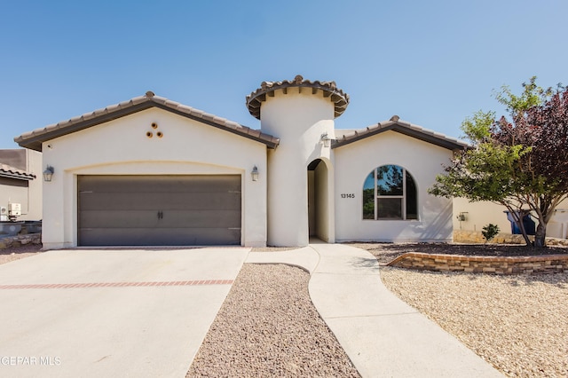13145 Hazy, El Paso, TX 79938 - mediterranean / spanish home featuring concrete driveway, an attached garage, stucco siding, and a tile roof