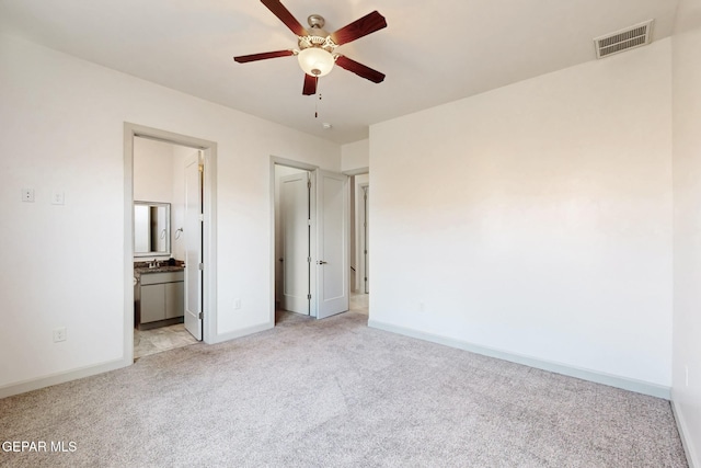 337 Vin Almoradi Ct, El Paso, TX 79912 - unfurnished bedroom with baseboards, visible vents, ensuite bathroom, and light colored carpet