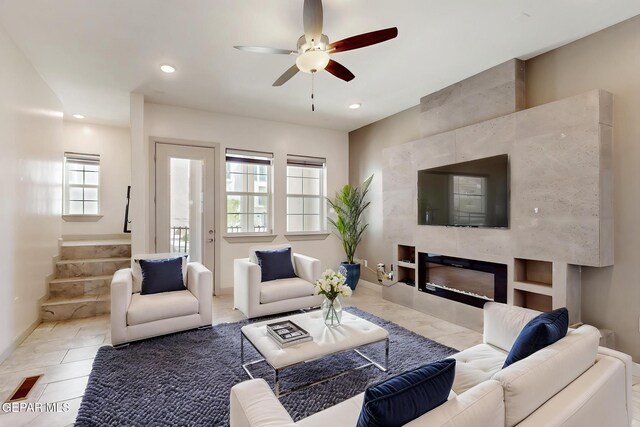 337 Vin Almoradi Ct, El Paso, TX 79912 - living room with recessed lighting, stairway, a tiled fireplace, ceiling fan, and baseboards