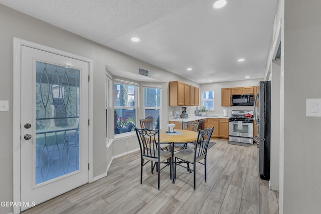 dining area featuring baseboards, recessed lighting, and light wood-style flooring