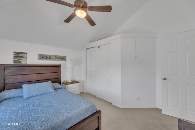 bedroom featuring a ceiling fan, light carpet, a closet, and vaulted ceiling