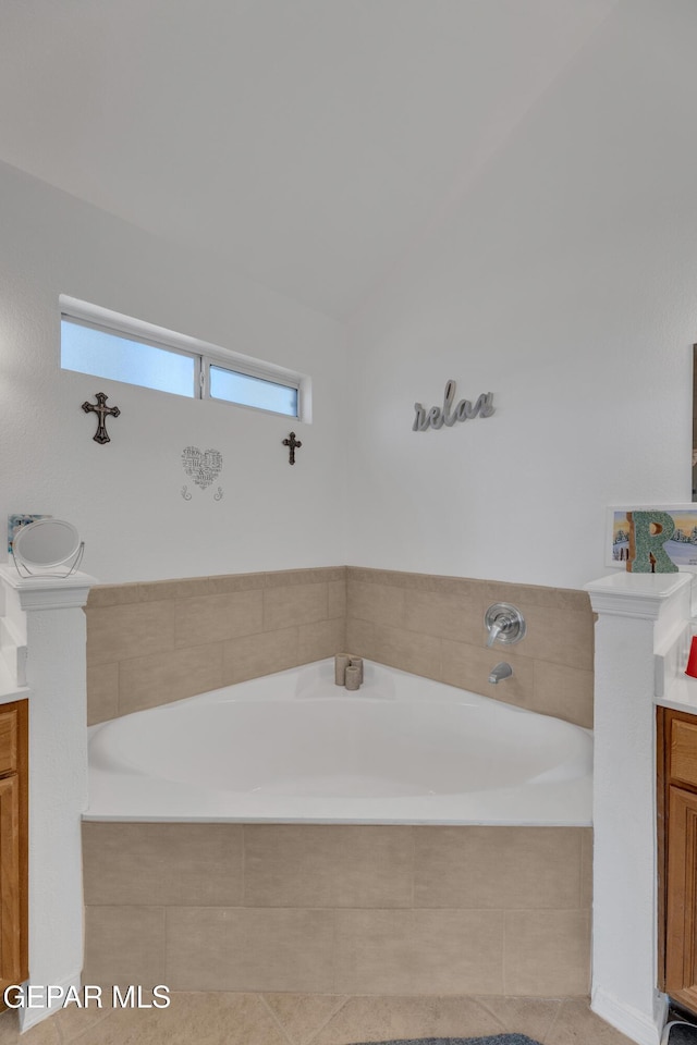 full bathroom with vanity, plenty of natural light, and a bath