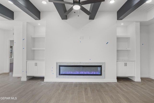 unfurnished living room featuring beamed ceiling, visible vents, baseboards, and light wood-style flooring