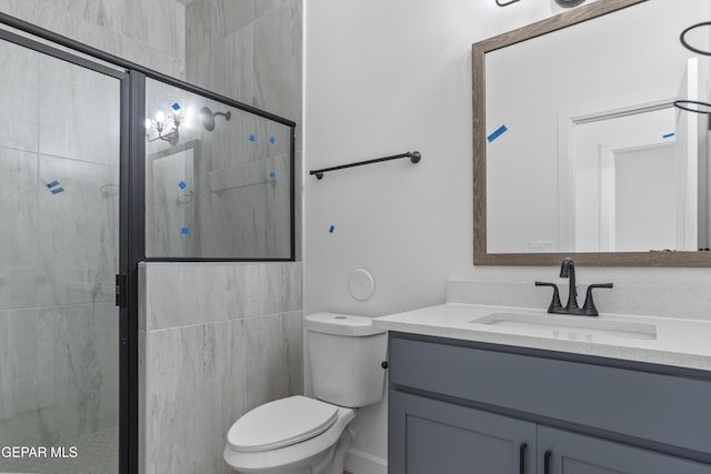 full bathroom featuring vanity, a stall shower, and toilet