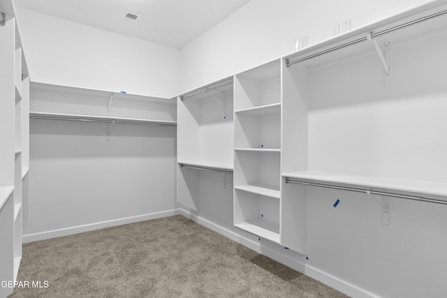 spacious closet with carpet and visible vents