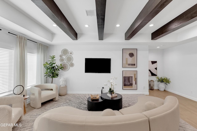 living area with beamed ceiling, recessed lighting, wood finished floors, and visible vents