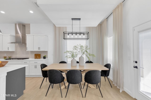 dining room featuring plenty of natural light, light wood-style flooring, and visible vents