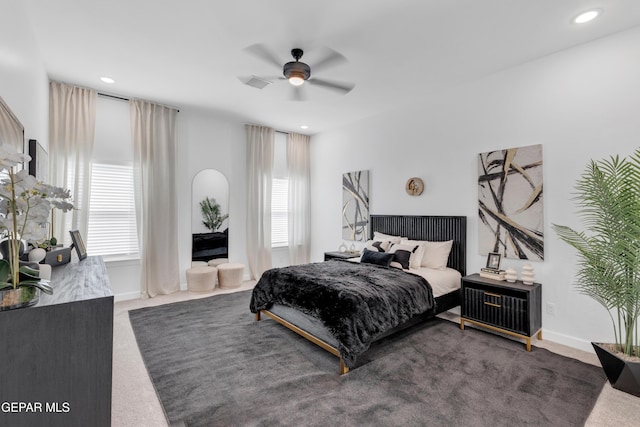 bedroom with carpet floors, a ceiling fan, baseboards, and visible vents