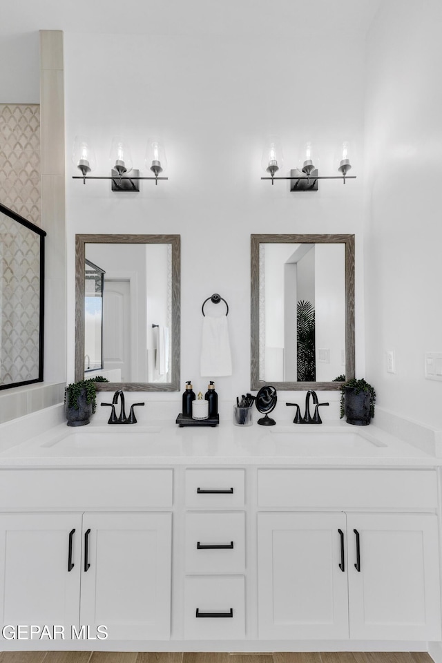 full bathroom with double vanity and a sink