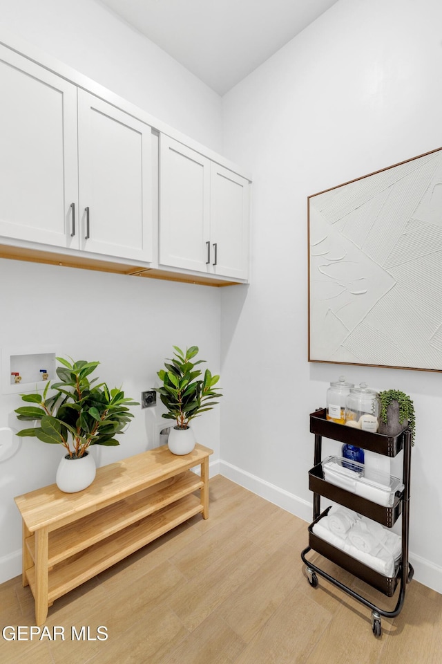 interior space featuring baseboards and light wood-type flooring