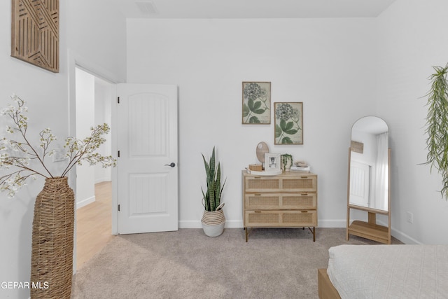 carpeted bedroom with arched walkways, baseboards, and visible vents