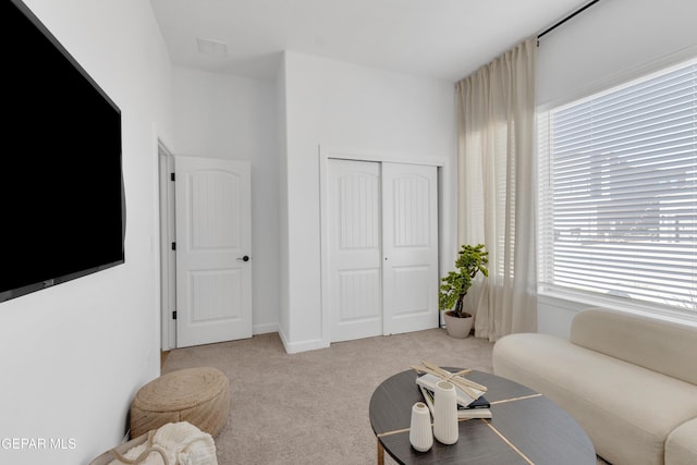 living area featuring carpet flooring and visible vents