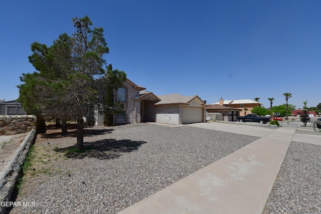 view of front of home featuring concrete driveway and an attached garage